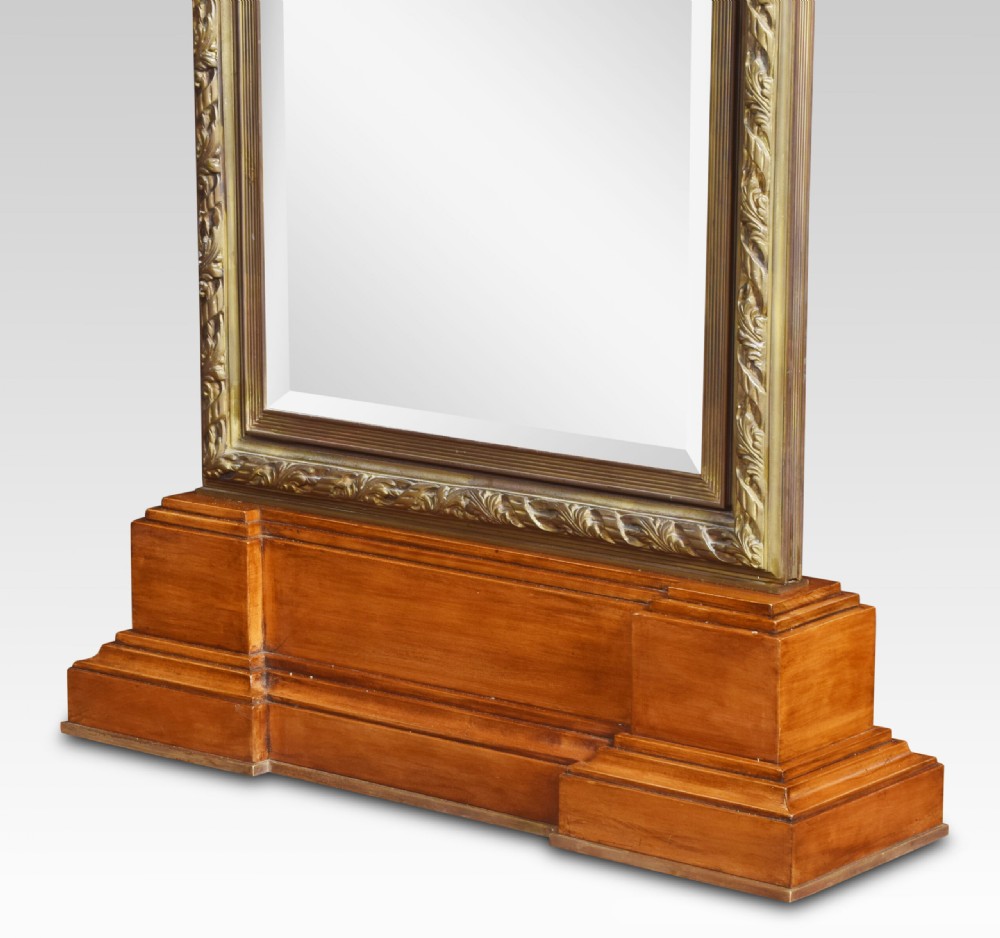 A pair of tall double-sided cheval mirrors featuring tooled bronze frames and wooden plinth bases. View XII
