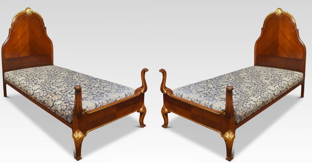 Pair of Walnut and Parcel gilt beds