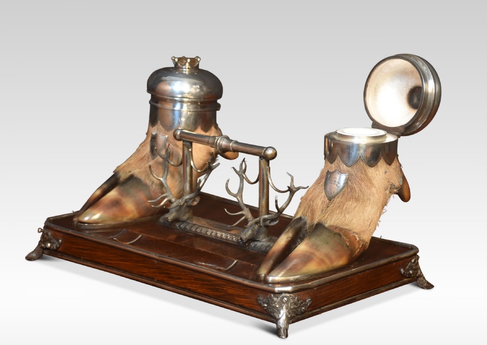 A 19th-century Scottish double inkwell set featuring two silver-capped deer hooves and stag head pen rests mounted on a mahogany base. View IV