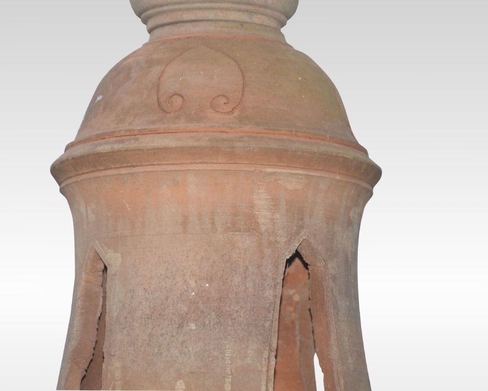 A pair of tall terracotta garden lanterns designed in the shape of stupas with elephant-carved bases, tiered lotus motifs, and pointed finials. View III