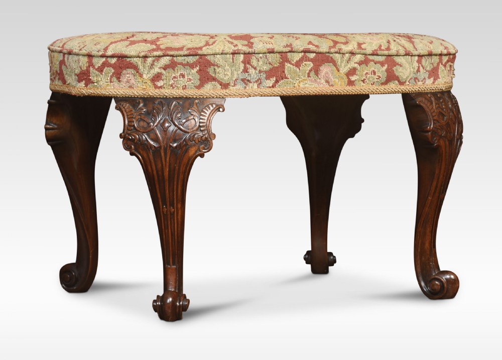 An oval George II style stool featuring patterned tapestry upholstery, carved mahogany cabriole legs, and scroll feet. View II