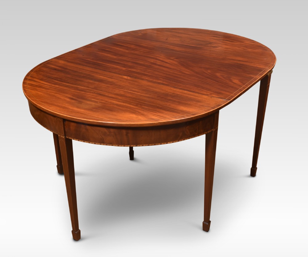 A Georgian flame mahogany D-end dining table featuring tapered square legs with stringing inlay and a polished wood top.