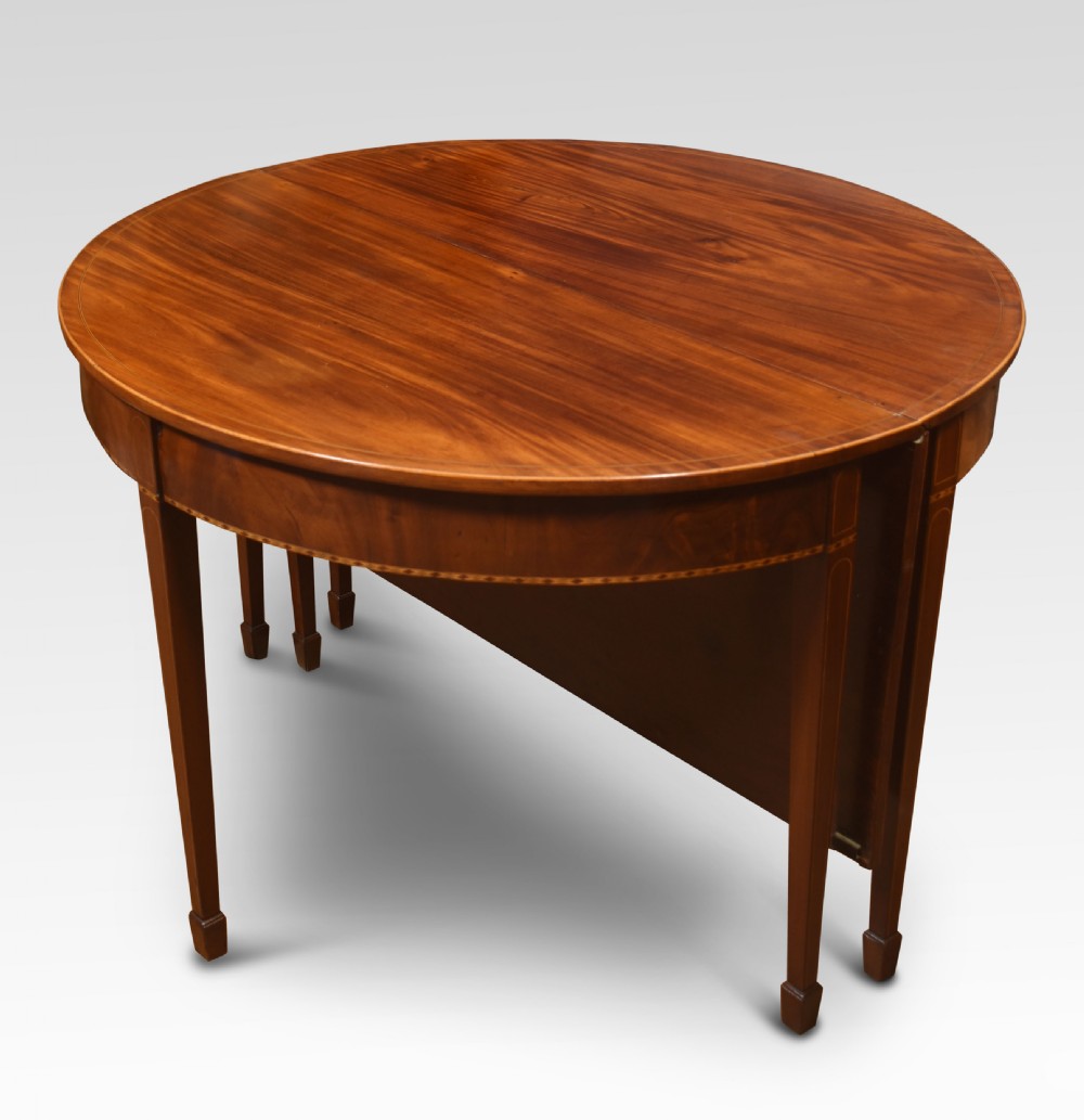 A Georgian flame mahogany D-end dining table featuring tapered square legs with stringing inlay and a polished wood top. View III