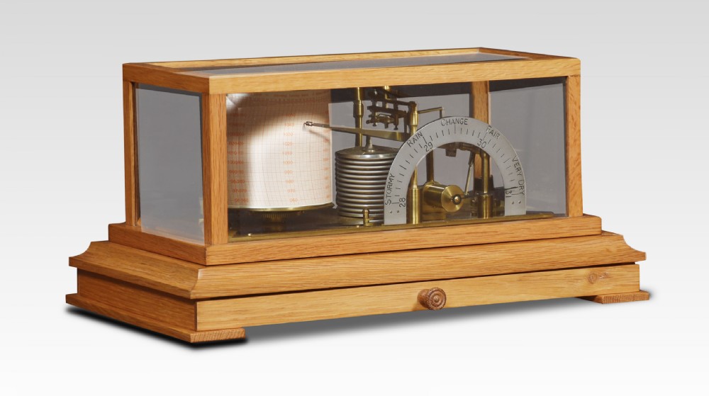 An antique oak and glass cased barograph by Negretti and Zambra featuring an internal clockwork drum, aneroid capsule stack, curved silvered scale, and base drawer.