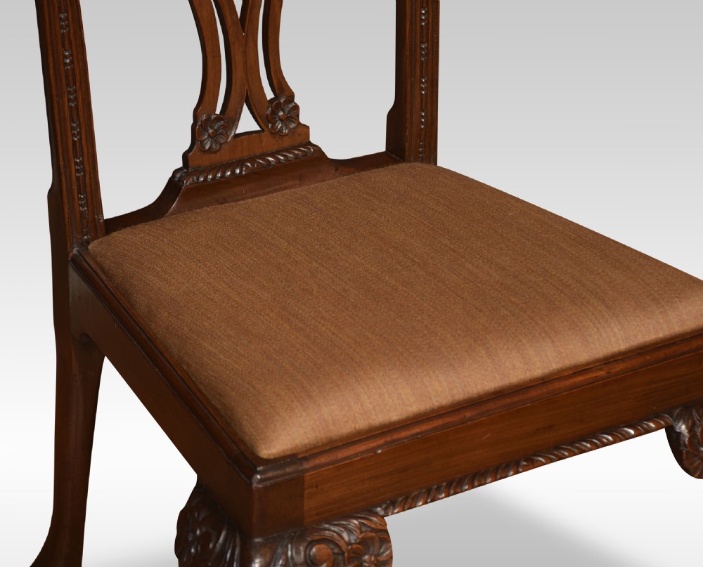 A pair of Chippendale Revival mahogany side chairs with carved pierced back splats, cabriole legs terminating in claw and ball feet, and light brown upholstered seats. View III