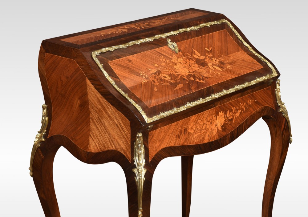 An antique French rosewood bureau de dame featuring floral marquetry inlays, gilt-bronze mounts, a sloped writing fall, and slender cabriole legs. View II