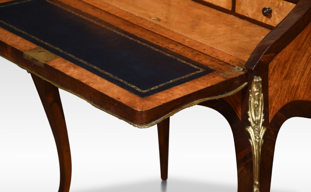 An antique French rosewood bureau de dame featuring floral marquetry inlays, gilt-bronze mounts, a sloped writing fall, and slender cabriole legs. View X