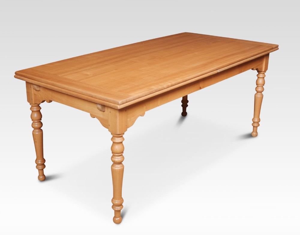 A large fruitwood farmhouse dining table featuring a framed plank top with breadboard ends and turned legs. View II