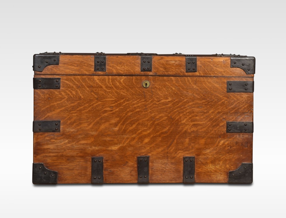 A 19th-century oak silver chest reinforced with black iron corner brackets and strapwork, shown with its lid open to display a blue padded fabric interior lining. View III