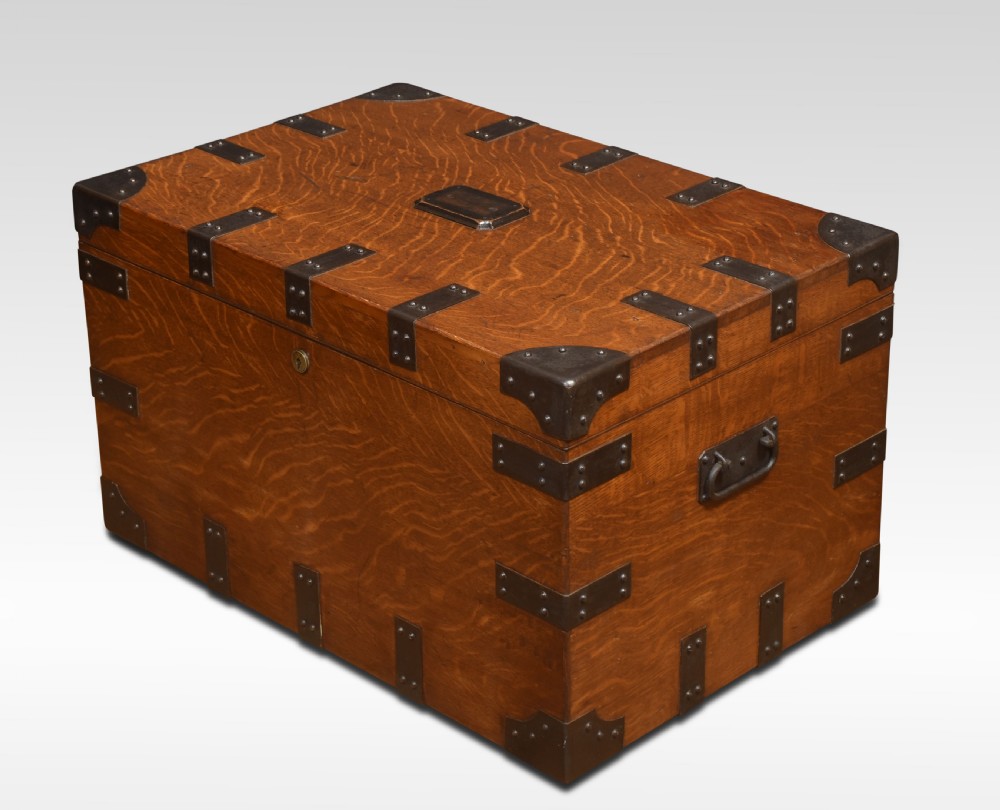 A 19th-century oak silver chest reinforced with black iron corner brackets and strapwork, shown with its lid open to display a blue padded fabric interior lining. View V