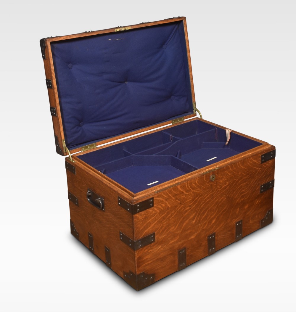 A 19th-century oak silver chest reinforced with black iron corner brackets and strapwork, shown with its lid open to display a blue padded fabric interior lining. View VII