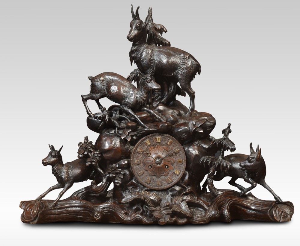 A nineteenth-century Black Forest carved wood mantel clock garniture set featuring sculpted alpine chamois figures atop rocky outcrops. View VII
