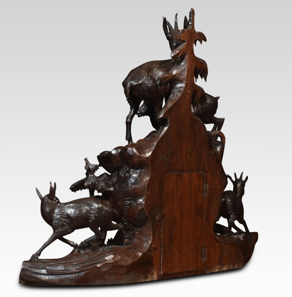 A nineteenth-century Black Forest carved wood mantel clock garniture set featuring sculpted alpine chamois figures atop rocky outcrops. View XI