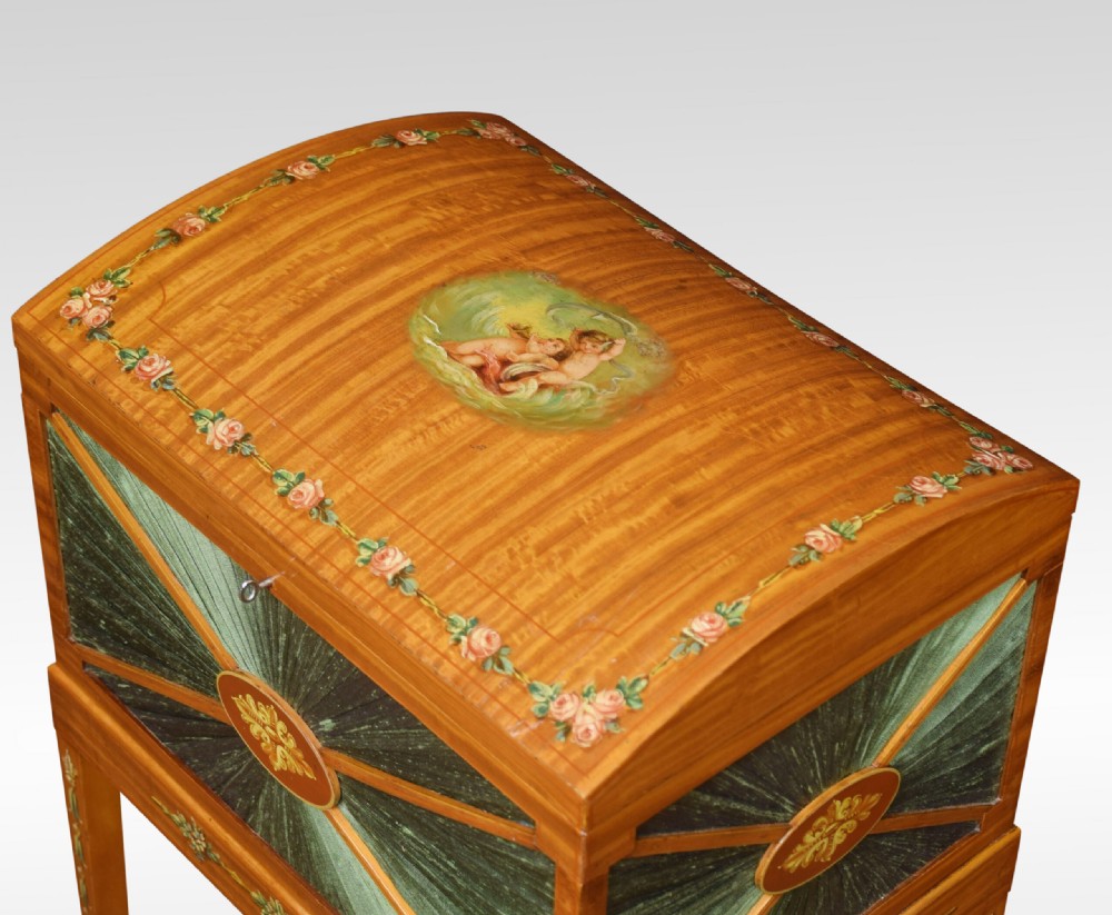 An antique painted satinwood ladies sewing table featuring open lid storage, pleated green silk side panels, and hand-painted floral decorations on tapered legs. View VIII