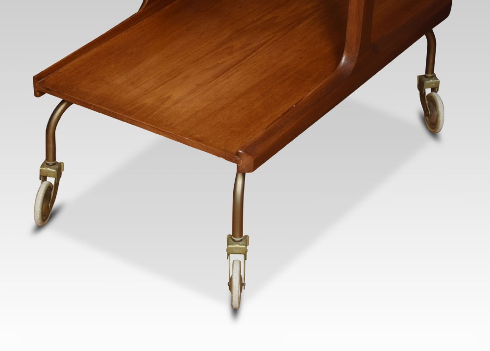 A mid-century modern two-tier walnut drinks trolley with sculpted handles and brass castors. View III