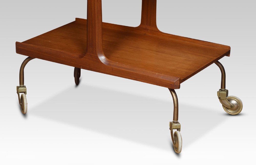 A mid-century modern two-tier walnut drinks trolley with sculpted handles and brass castors. View VI