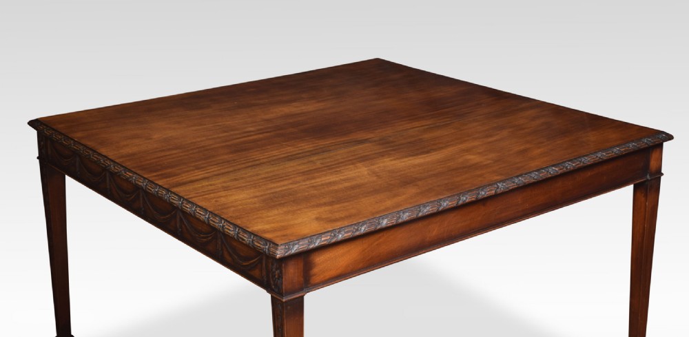 An Adam Revival mahogany centre table featuring a square top with carved edge moulding, a drapery-carved apron, and four tapered square legs. View III