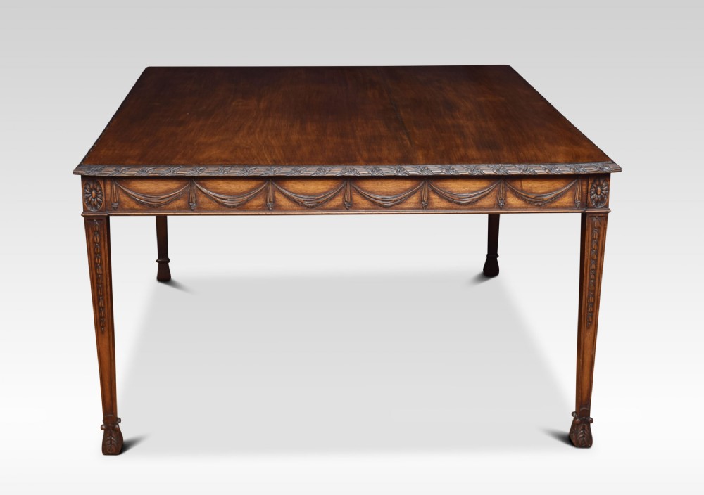 An Adam Revival mahogany centre table featuring a square top with carved edge moulding, a drapery-carved apron, and four tapered square legs. View VI