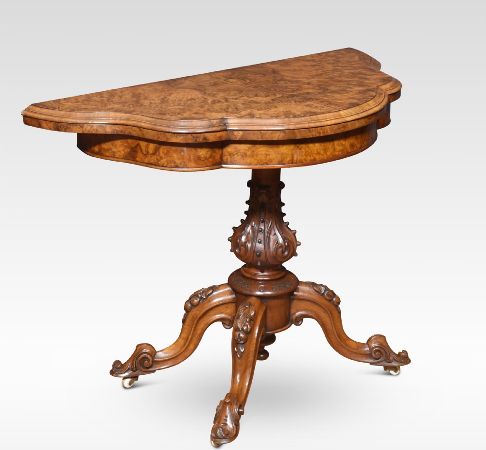 An antique Victorian burr walnut card table featuring a shaped serpentine top lined with green baize, resting on a carved pedestal stem and tripod cabriole legs. View II