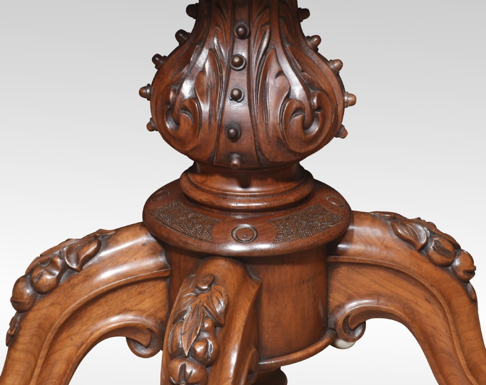 An antique Victorian burr walnut card table featuring a shaped serpentine top lined with green baize, resting on a carved pedestal stem and tripod cabriole legs. View VI