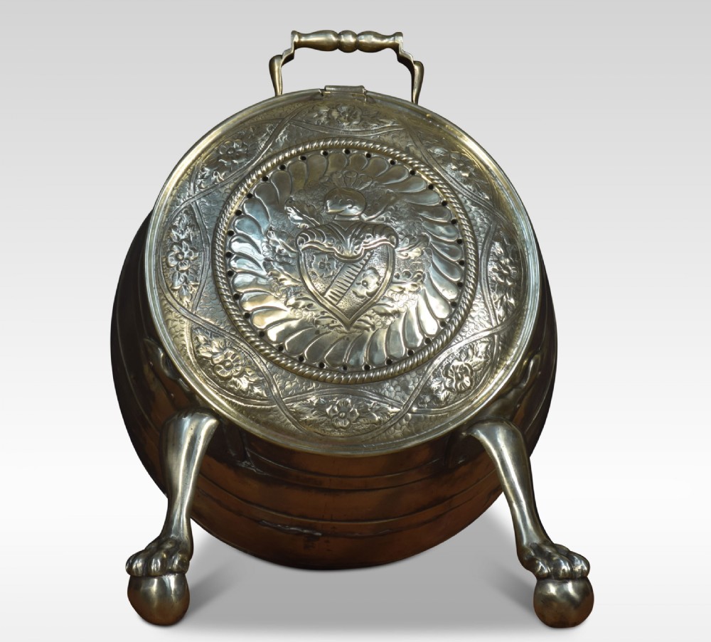 An antique spherical brass coal bin featuring a hinged repousse embossed lid supported by cast metal claw feet. View VI