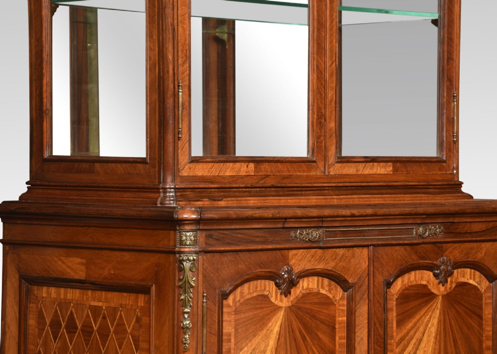 An antique French walnut display cabinet featuring a upper glazed vitrine with glass shelves, an arched crest, and a lower cupboard with sunburst parquetry veneer panels. View VII