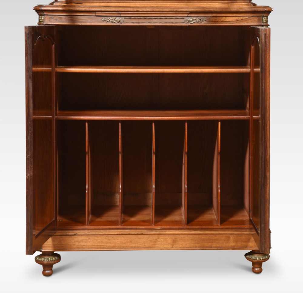 An antique French walnut display cabinet featuring a upper glazed vitrine with glass shelves, an arched crest, and a lower cupboard with sunburst parquetry veneer panels. View VIII