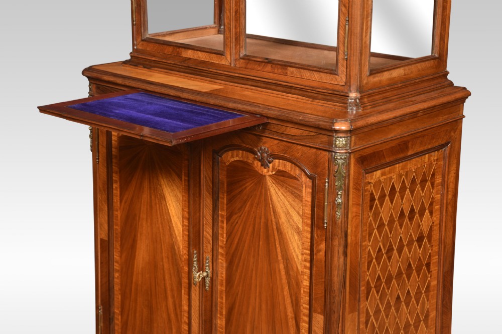An antique French walnut display cabinet featuring a upper glazed vitrine with glass shelves, an arched crest, and a lower cupboard with sunburst parquetry veneer panels. View XI