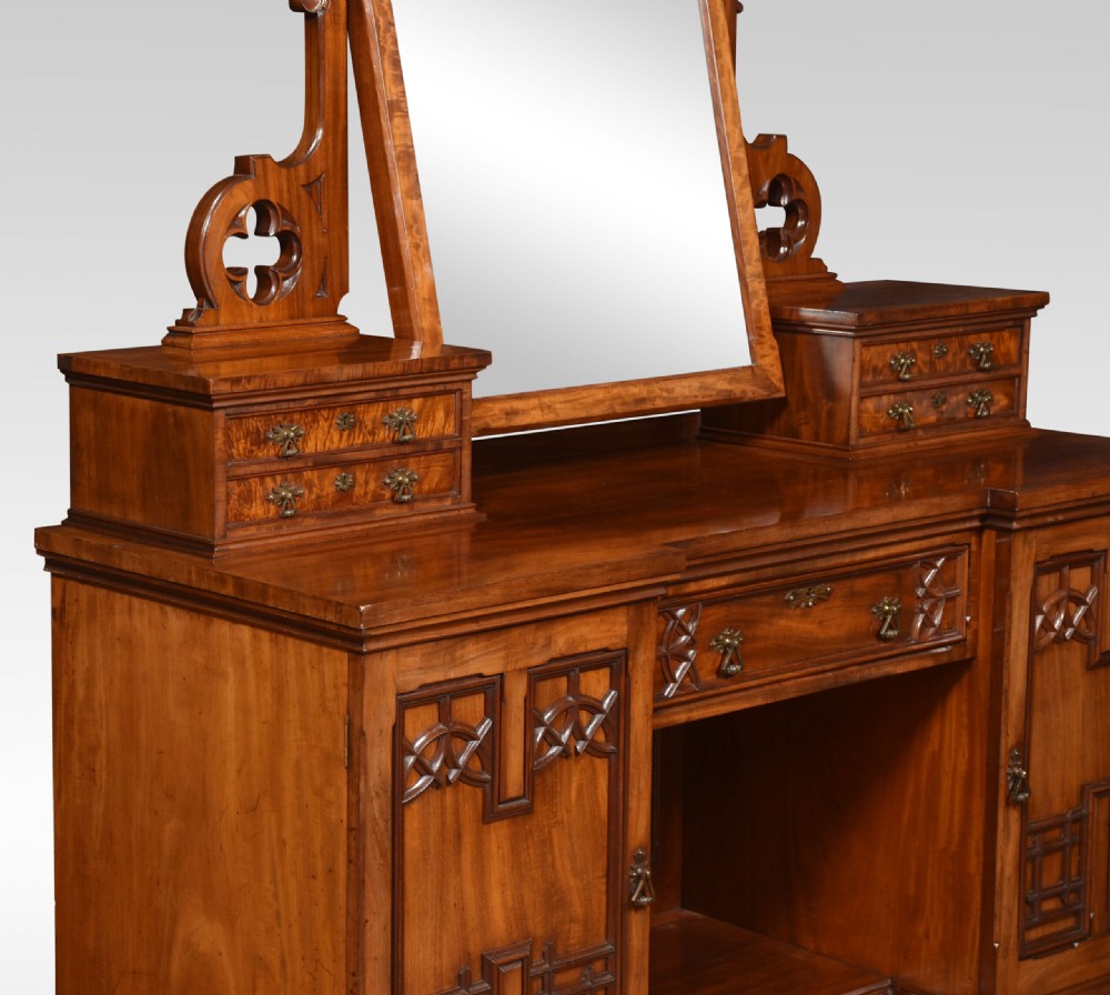 An antique Gothic Revival mahogany dressing table featuring a central adjustable mirror, raised trinket drawers, and carved tracery cupboard doors. View V