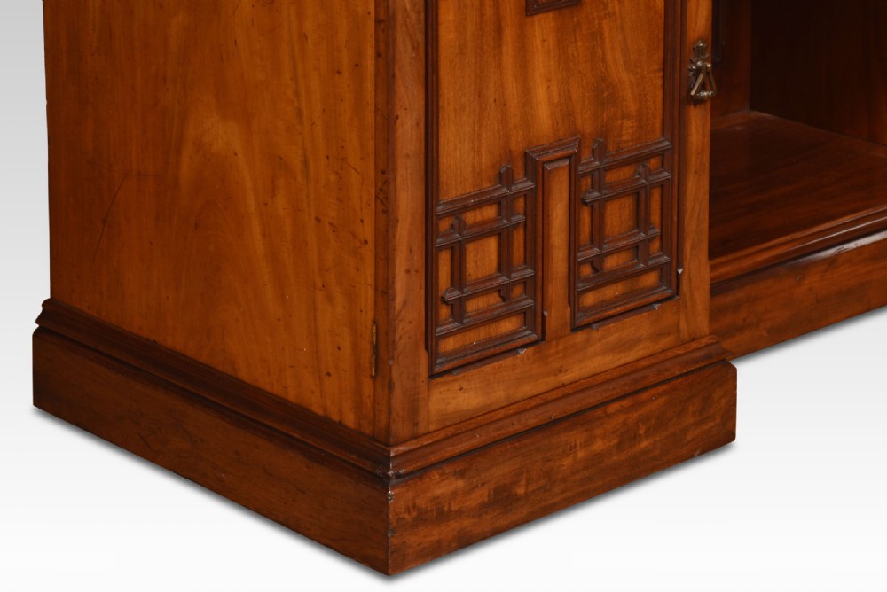 An antique Gothic Revival mahogany dressing table featuring a central adjustable mirror, raised trinket drawers, and carved tracery cupboard doors. View VI
