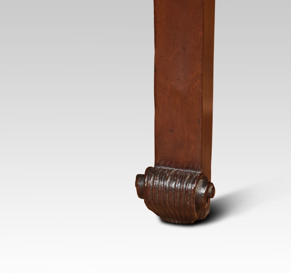 A George III mahogany serving table featuring a serpentine front top, shaped apron, and slender tapered legs terminating in scrolled toes. View VII