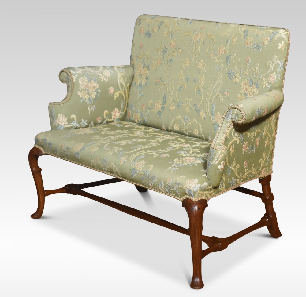 A two-seat Queen Anne style settee upholstered in green floral damask fabric with polished walnut cabriole legs and stretchers. View V