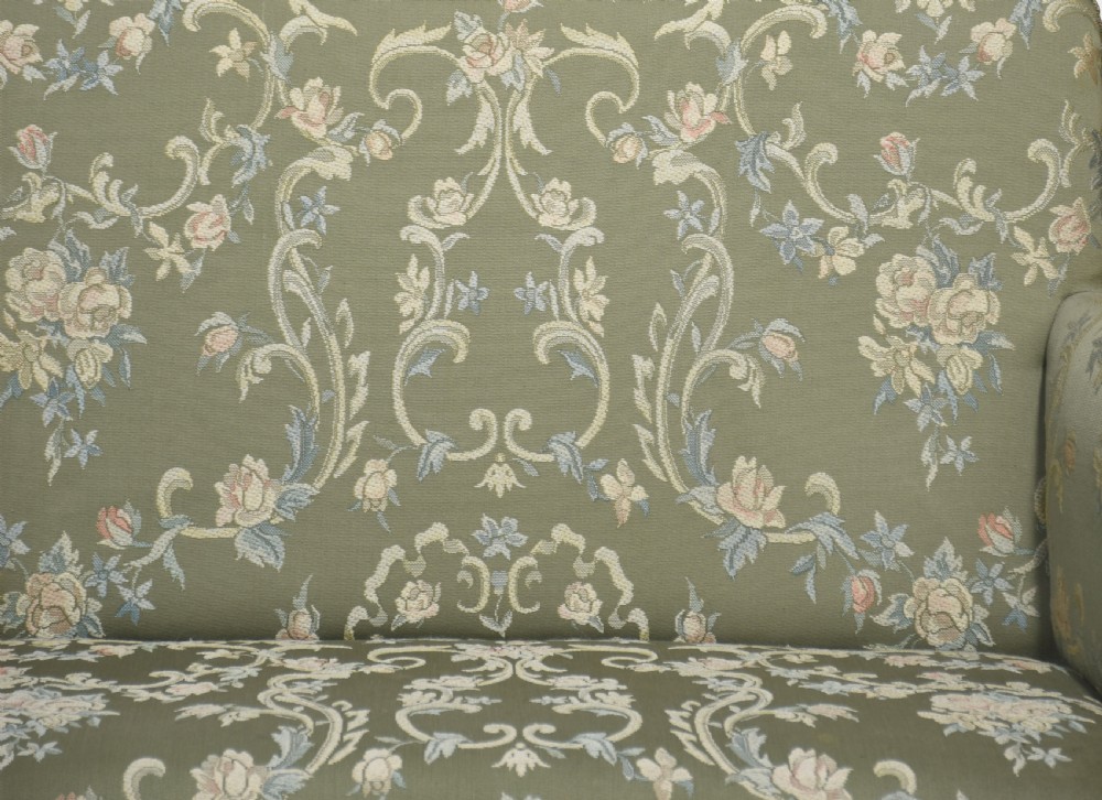 A two-seat Queen Anne style settee upholstered in green floral damask fabric with polished walnut cabriole legs and stretchers. View VIII
