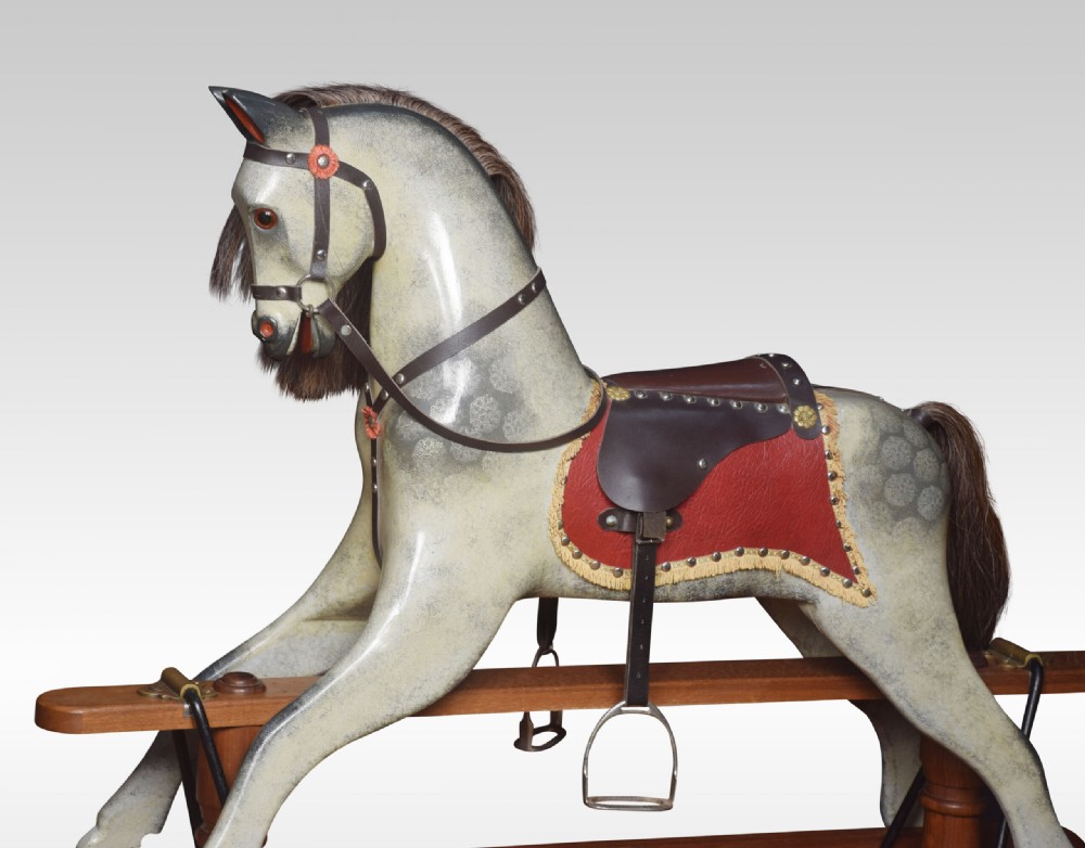 A carved pine rocking horse featuring a dappled grey finish, natural horsehair mane, and leather saddle mounted on a pine safety stand. View III