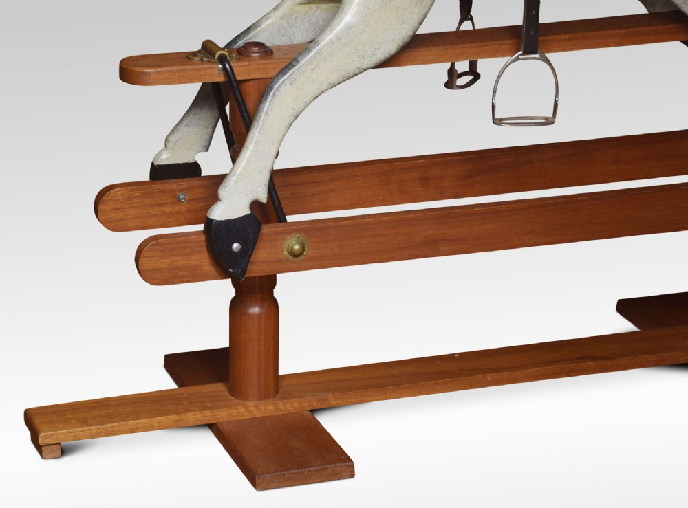 A carved pine rocking horse featuring a dappled grey finish, natural horsehair mane, and leather saddle mounted on a pine safety stand. View VI