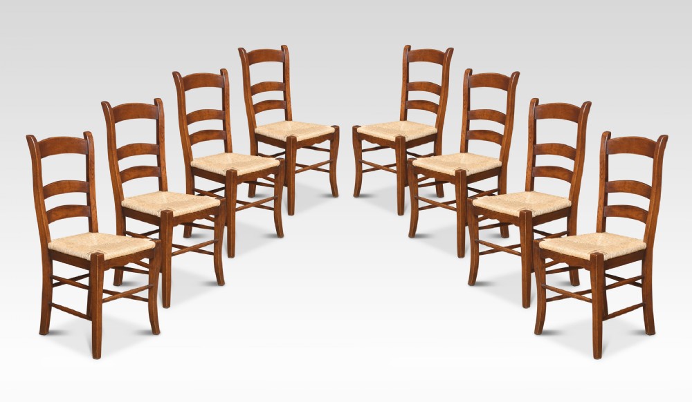 Set of eight oak ladder back dining chairs
