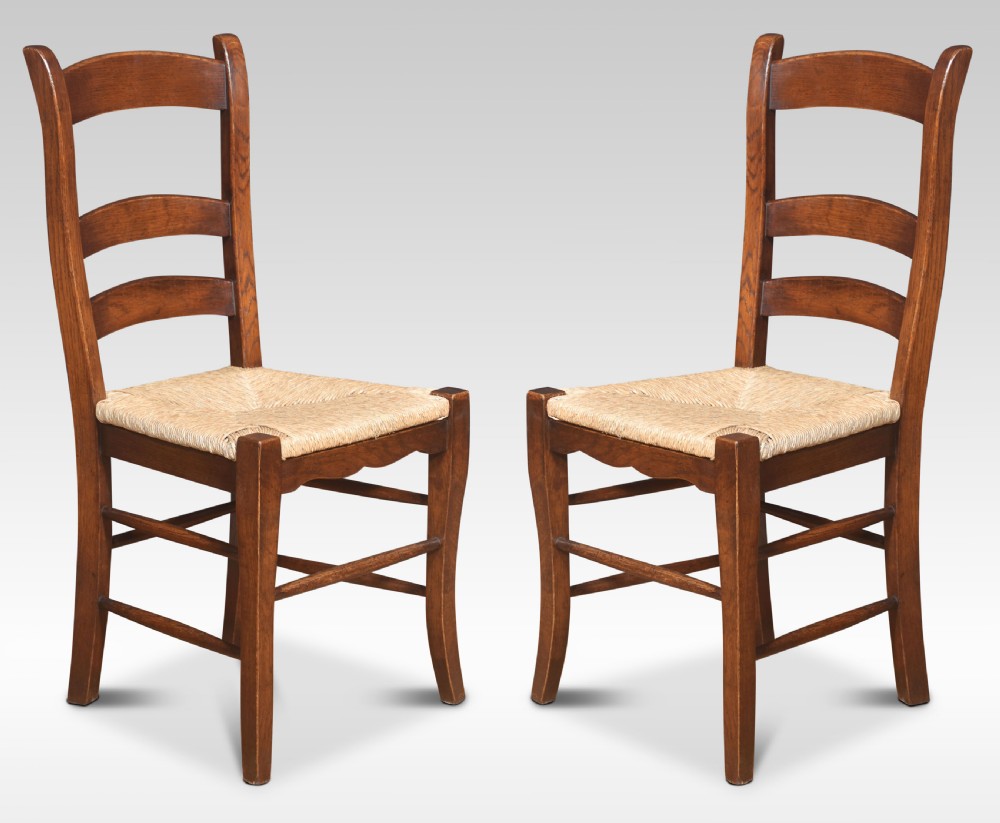Set of eight oak ladder back dining chairs View II