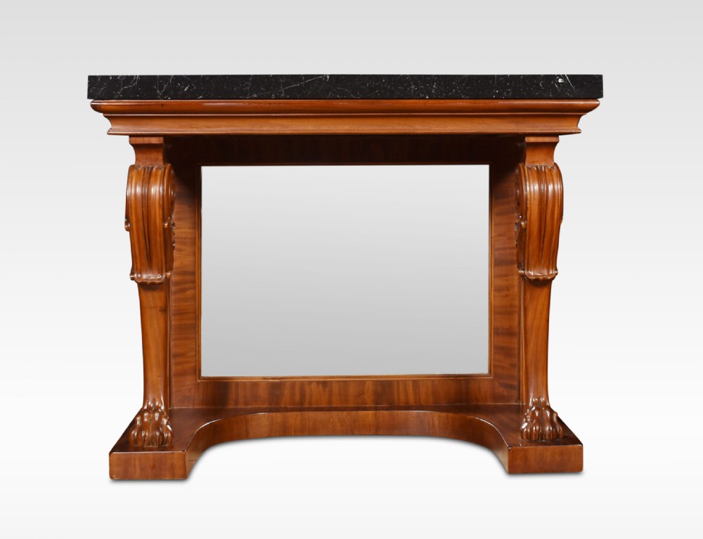 A Regency mahogany console table featuring a black marble top, scroll front legs with carved paw feet, a mirrored back plate, and a concave base. View II