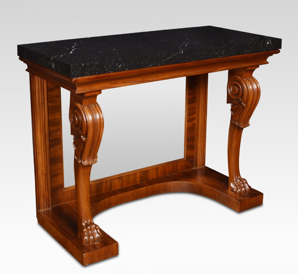 A Regency mahogany console table featuring a black marble top, scroll front legs with carved paw feet, a mirrored back plate, and a concave base. View III