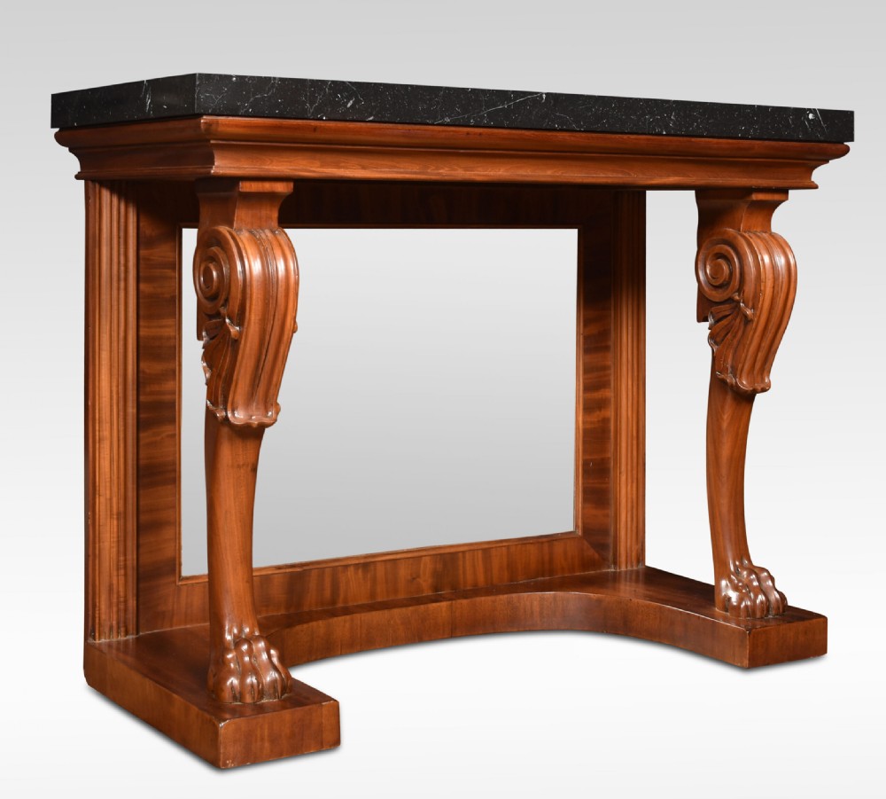 A Regency mahogany console table featuring a black marble top, scroll front legs with carved paw feet, a mirrored back plate, and a concave base. View IV