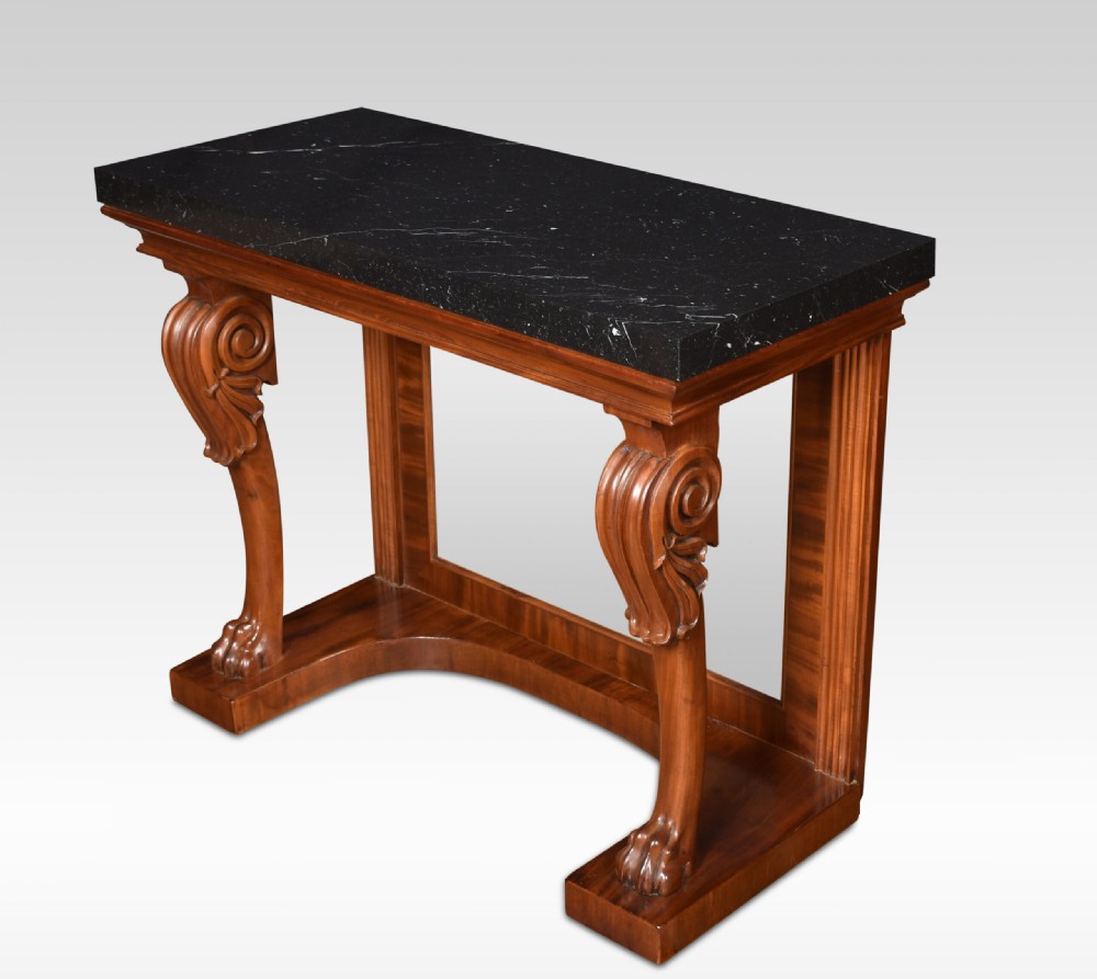 A Regency mahogany console table featuring a black marble top, scroll front legs with carved paw feet, a mirrored back plate, and a concave base. View VIII