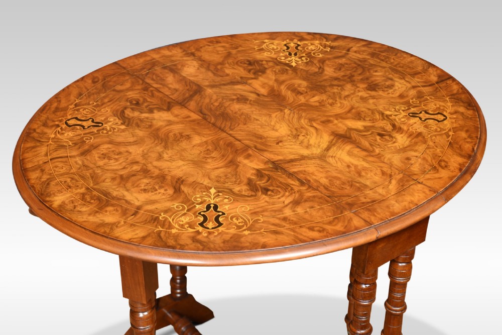 Victorian burr walnut Sutherland table with floral marquetry inlay, turned spindle legs, and drop-down leaves. View VII