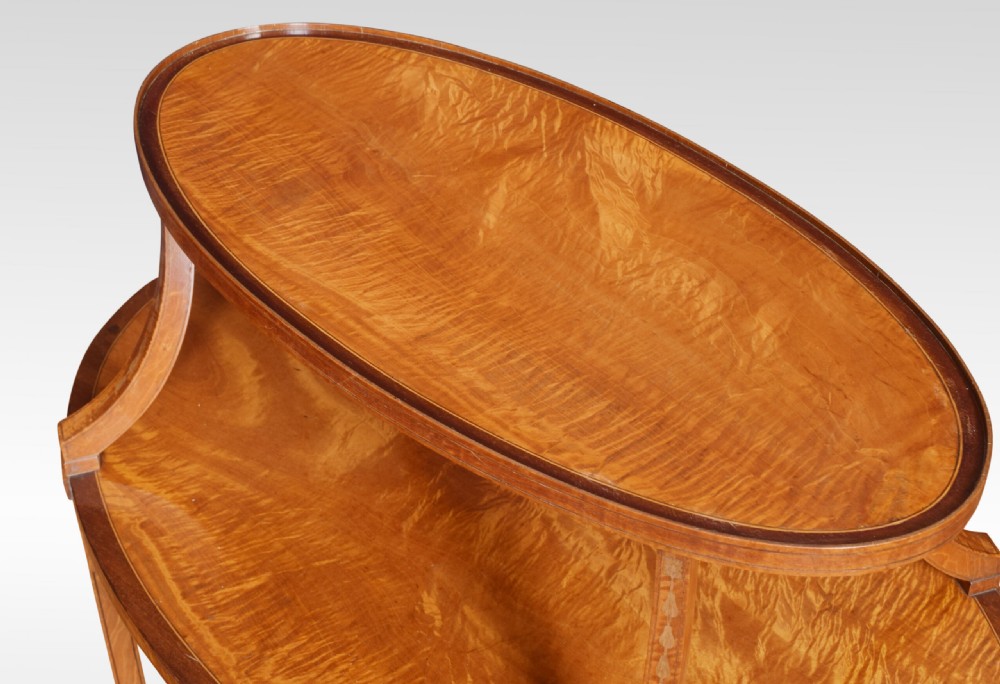 A two-tiered oval satinwood and mahogany etagere table featuring marquetry stringing, curved leg supports, and twin brass carrying handles. View VII