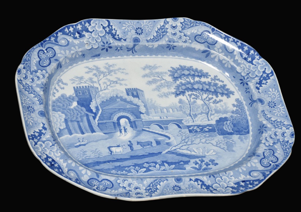 A pair of oblong blue and white transferware ceramic platters decorated with classical landscape scenes and floral borders. View II