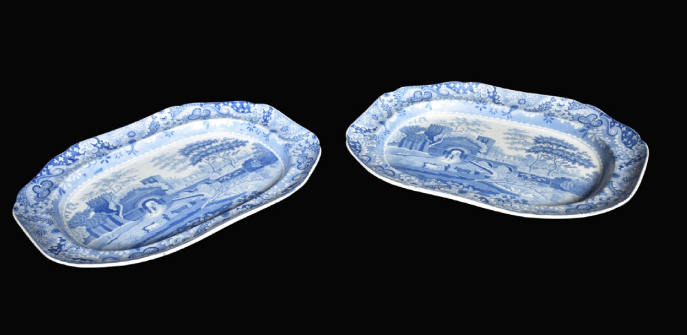 A pair of oblong blue and white transferware ceramic platters decorated with classical landscape scenes and floral borders. View V