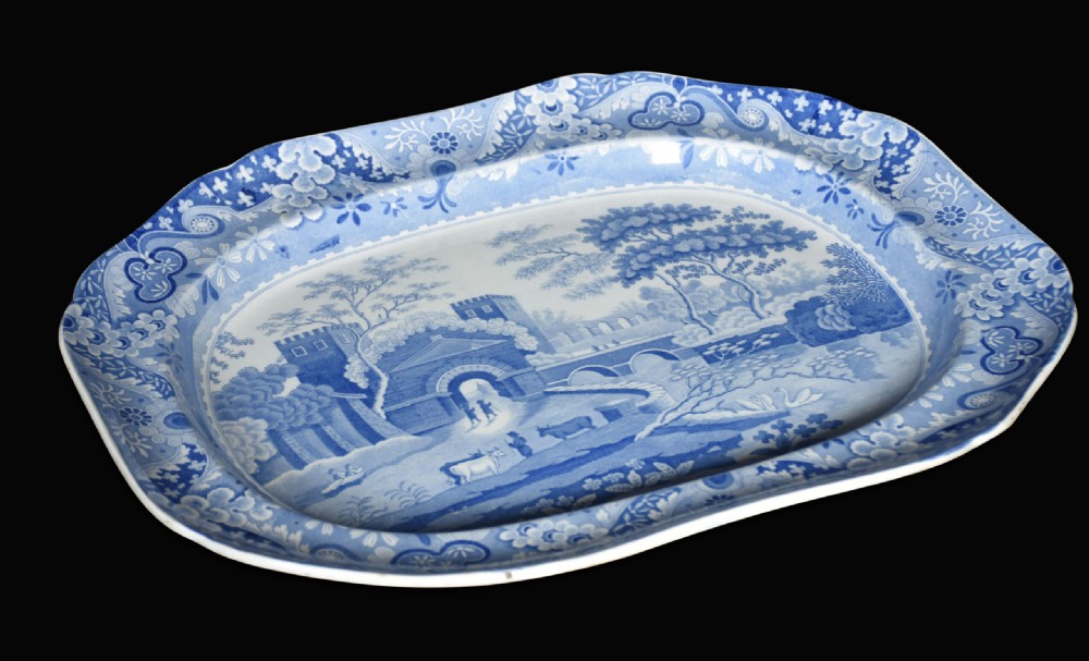 A pair of oblong blue and white transferware ceramic platters decorated with classical landscape scenes and floral borders. View VI