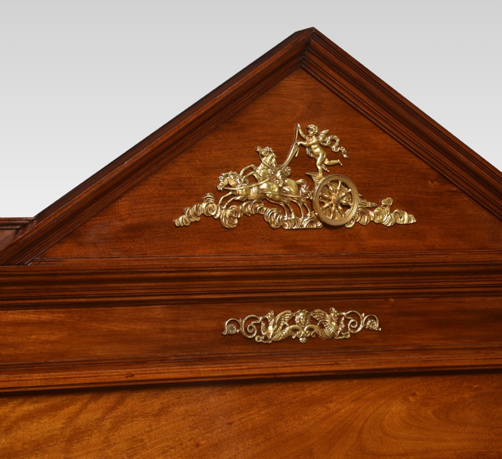 A French Empire style mahogany double bed frame featuring gilt brass mounts, turned feet, and a pediment headboard. View VIII