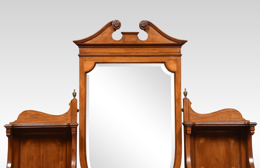 An Edwardian mahogany inlaid dressing table featuring a central oval mirror, upper trinket drawers, and twin pedestals with brass handles. View VI