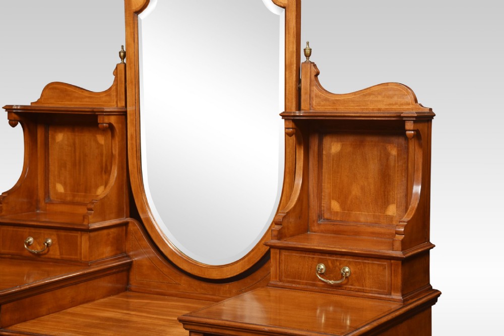 An Edwardian mahogany inlaid dressing table featuring a central oval mirror, upper trinket drawers, and twin pedestals with brass handles. View XII