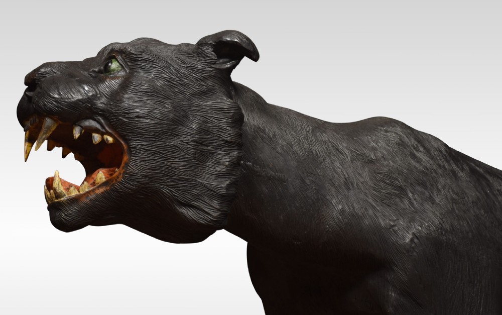 A nineteenth-century hand-carved wooden figure of a snarling black panther with glass eyes and an open painted mouth. View III